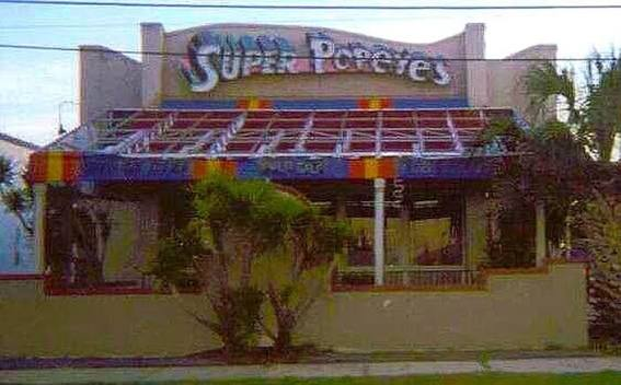 Vintage exterior photograph of a Super Popeyes restaurant with its distinctive rooftop wordmark